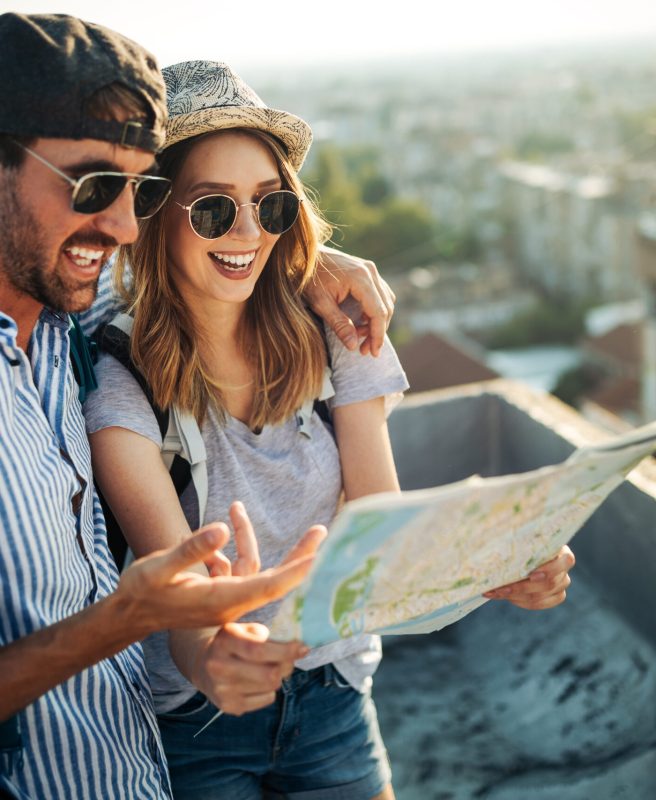 Young,Couple,Travelling,With,A,Map,In,The,City